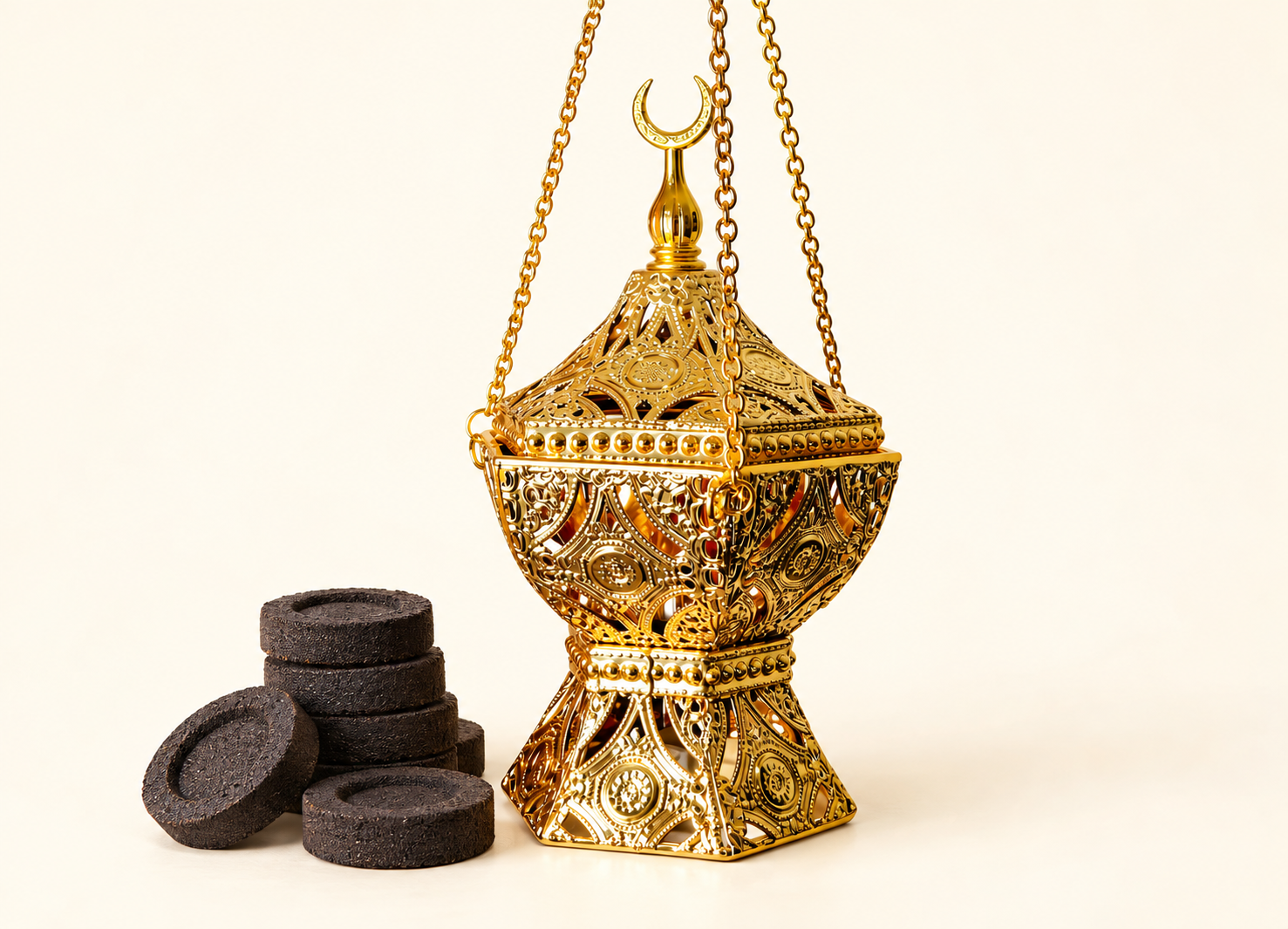 Ornate gold bakhoor burner with Arabic design, hanging chain, and incense smoke