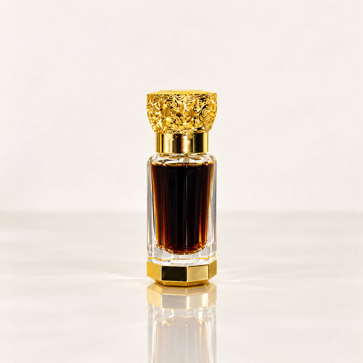 A clear glass perfume bottle with a textured gold cap and a gold hexagonal base, filled with dark amber liquid, centered on a reflective white surface against a light gray background.